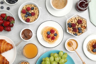 Photo of Delicious breakfast served on light grey marble table, flat lay