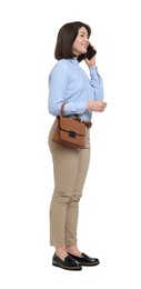 Photo of Happy woman with bag talking on smartphone against white background