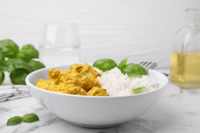 Photo of Delicious rice and chicken with curry sauce on white marble table, closeup