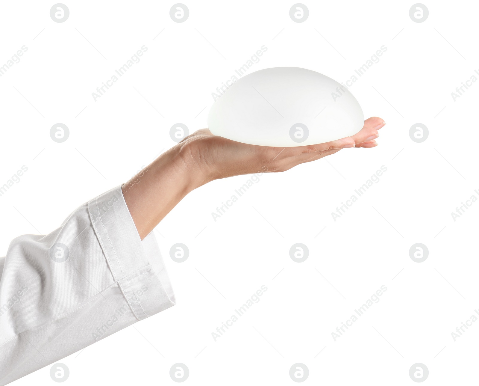 Photo of Doctor holding silicone implant for breast augmentation on white background. Cosmetic surgery