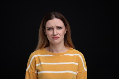 Photo of Portrait of sad woman on black background