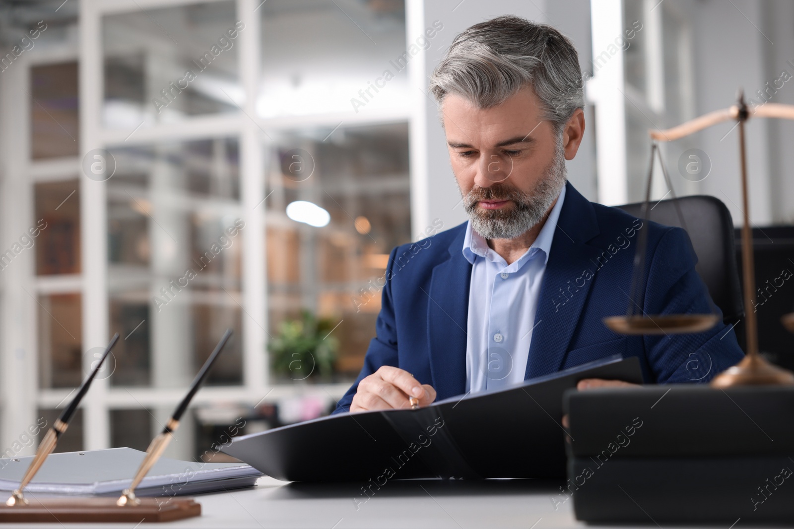 Photo of Portrait of serious lawyer in office, space for text