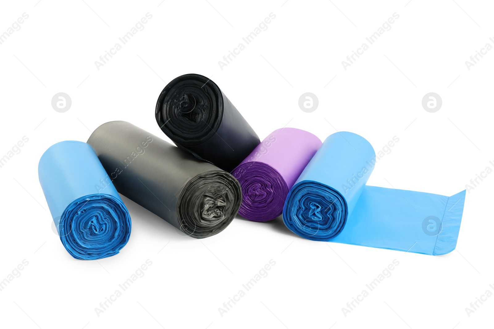 Photo of Rolls of different garbage bags on white background. Cleaning supplies