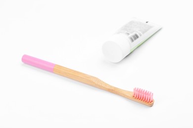 Photo of Bamboo toothbrush and paste isolated on white