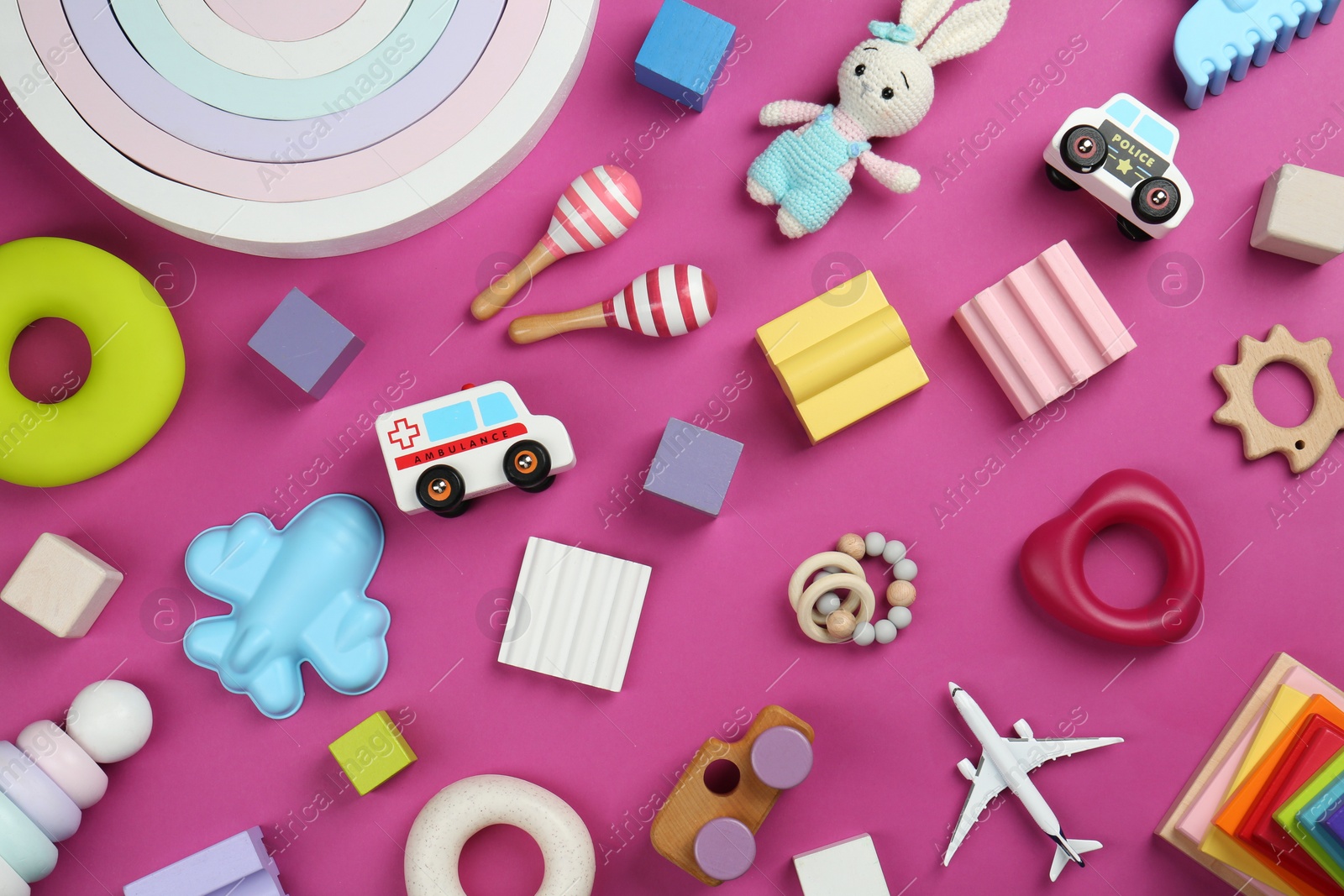 Photo of Different children's toys on magenta background, flat lay