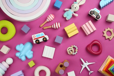 Photo of Different children's toys on magenta background, flat lay