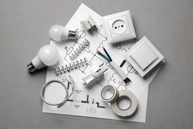 Photo of Flat lay composition with electrician's accessories on grey background