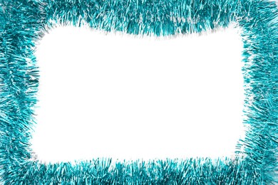 Photo of Frame of shiny light blue tinsel on white background, top view. Space for text