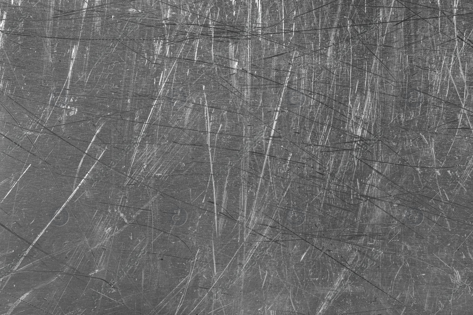 Photo of Texture of scratched metallic surface as background, closeup