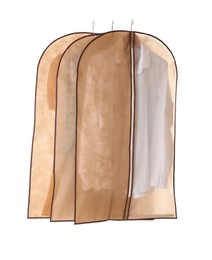 Garment bags with clothes on white background