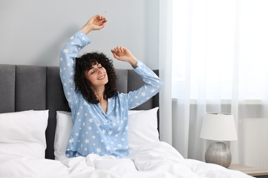 Photo of Beautiful young woman in stylish pyjama in bed at home
