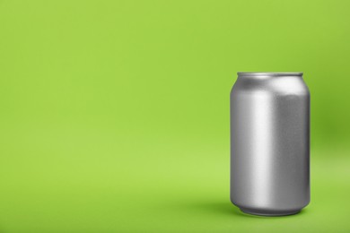 Photo of Can of energy drink on green background. Space for text
