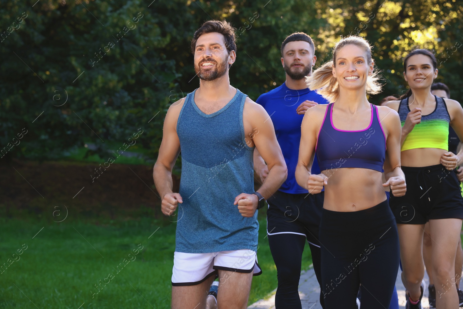 Photo of Group of people running in park. Active lifestyle