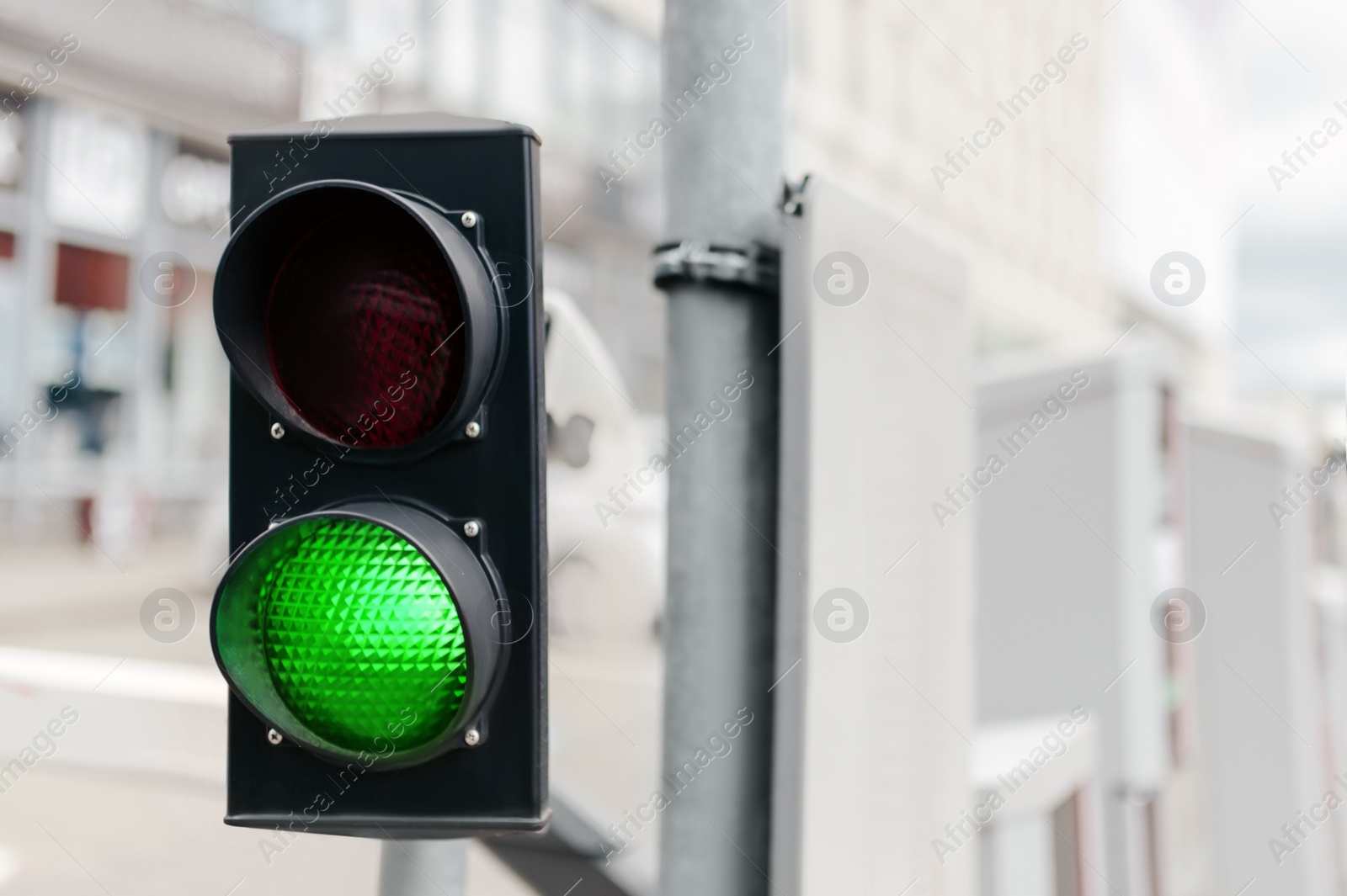 Photo of Traffic light on city street, space for text