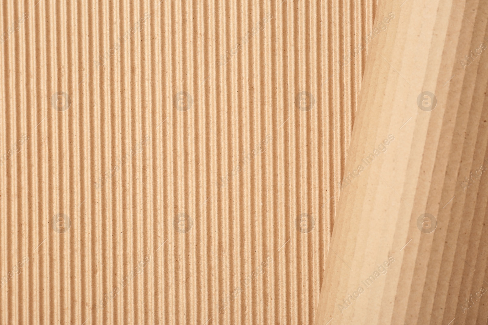 Photo of Corrugated cardboard as background, top view with space for text. Recyclable material