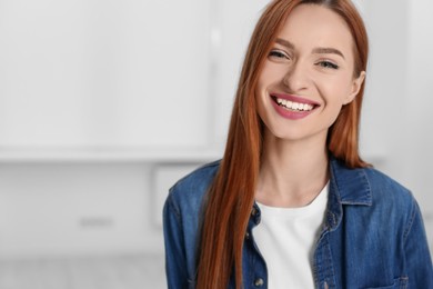 Portrait of beautiful young woman at home, space for text