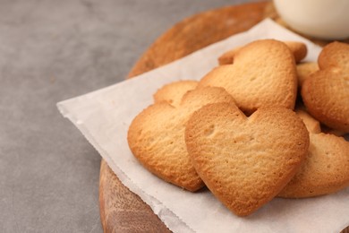 Photo of Heart shaped Danish butter cookies on grey table, closeup. Space for text