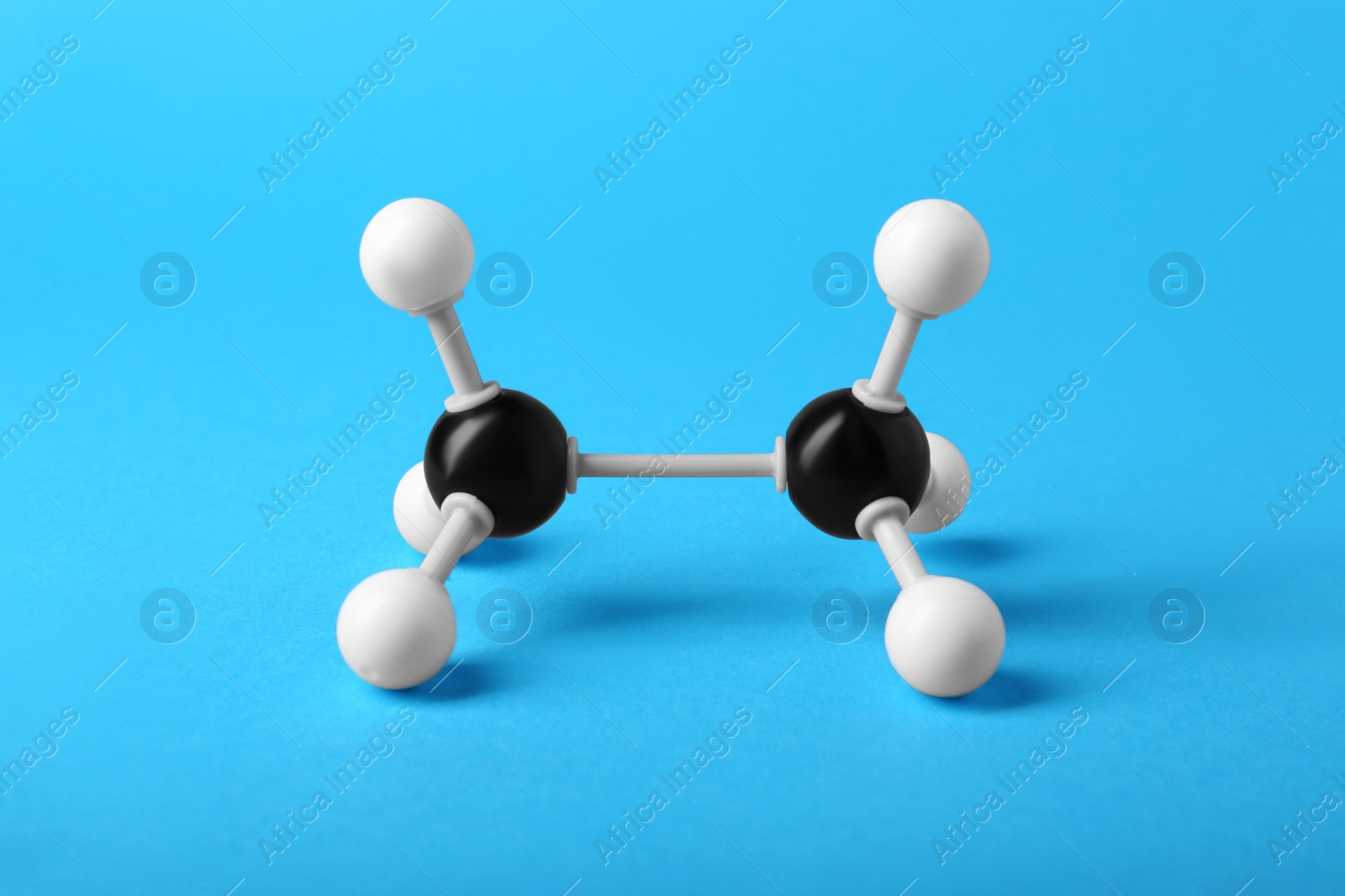 Photo of Molecule of alcohol on light blue background. Chemical model