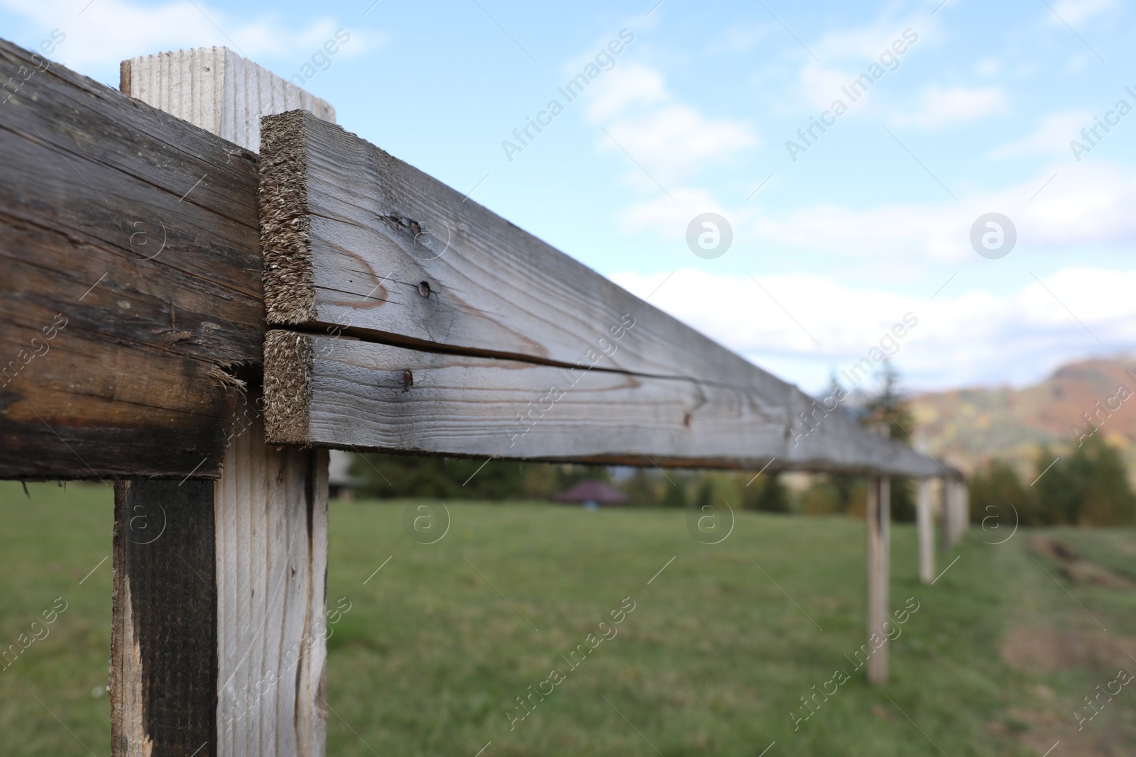 Photo of Closeup view of old wooden fence outdoors