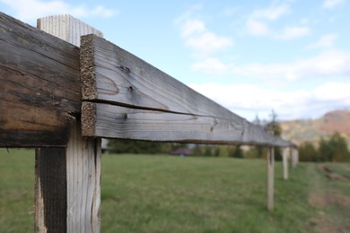 Closeup view of old wooden fence outdoors