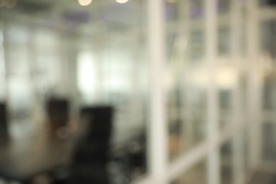 Blurred view of cozy workspaces with tables and chairs in office