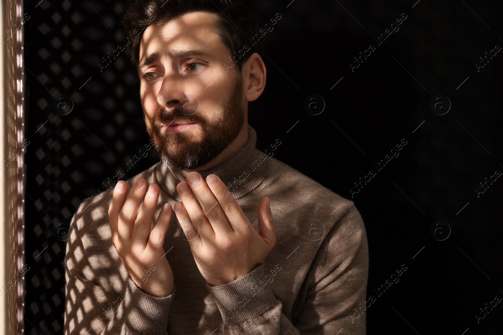 Photo of Upset man talking to priest during confession in booth, space for text