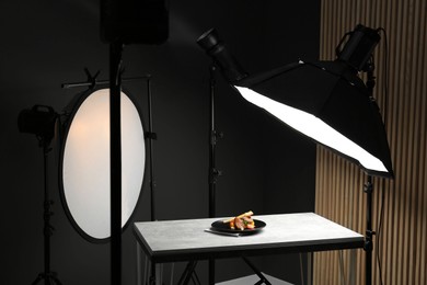 Photo of Composition with baked chicken, parsnip and strawberries on grey table in professional photo studio. Food photography