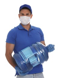Photo of Courier in medical mask holding bottle for water cooler on white background. Delivery during coronavirus quarantine
