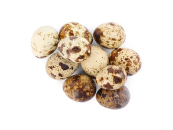 Photo of Many speckled quail eggs on white background, top view