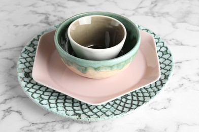 Stack of clean dishes on white marble table