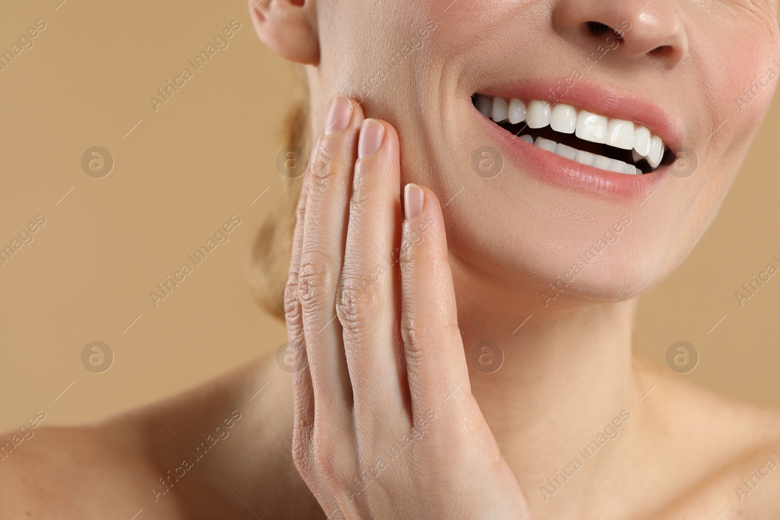 Photo of Woman with healthy skin on beige background, closeup