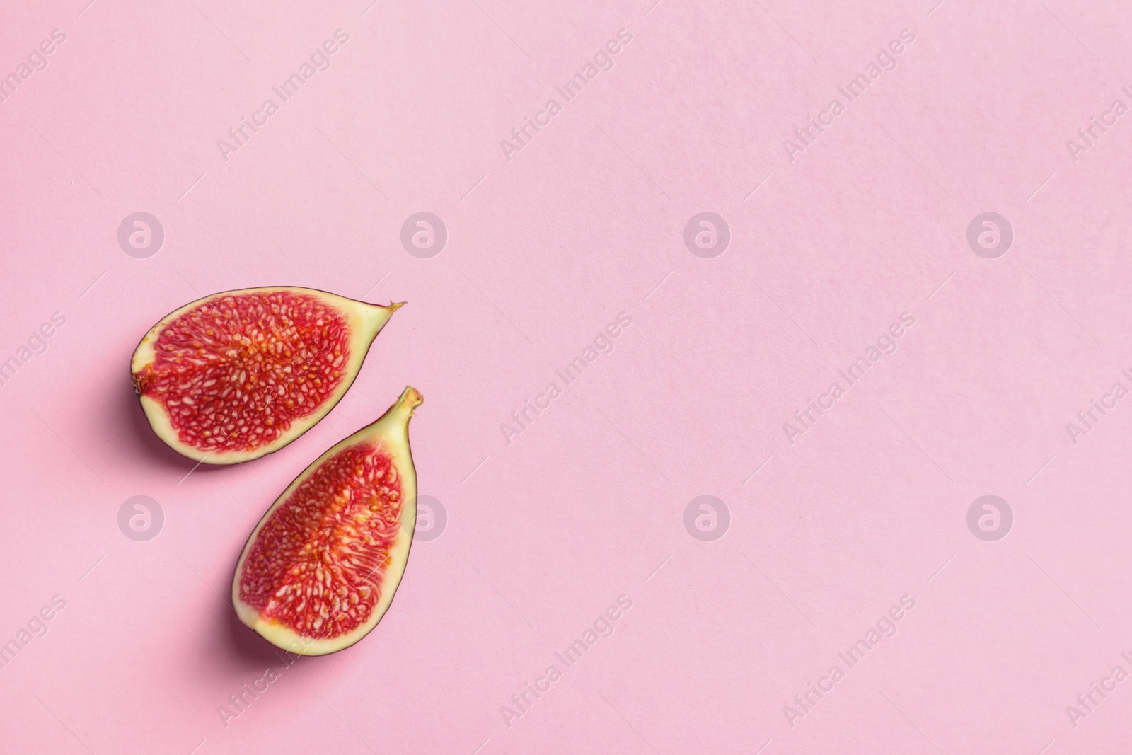 Photo of Fresh ripe fig slices on color background, top view. Space for text