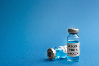 Photo of Chickenpox vaccine on blue background, space for text. Varicella virus prevention