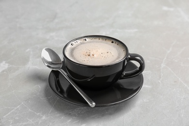 Photo of Cup of aromatic hot coffee on marble background
