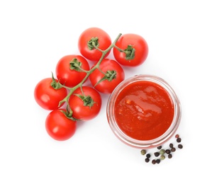 Photo of Jar of sauce and tomatoes isolated on white, top view
