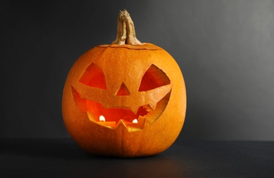 Photo of Halloween pumpkin head jack lantern on dark background