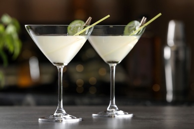 Photo of Glasses of tasty cucumber martini on bar counter