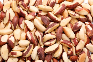 Photo of Many delicious Brazil nuts as background, top view