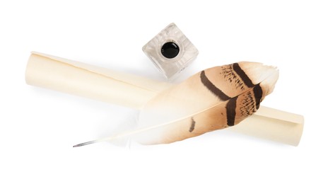 Photo of Feather pen, inkwell and scroll of parchment on white background, top view