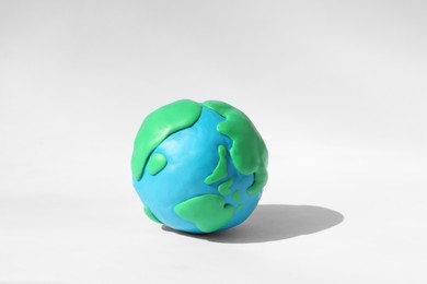 Photo of Planet Earth model made of colorful plasticine on white background