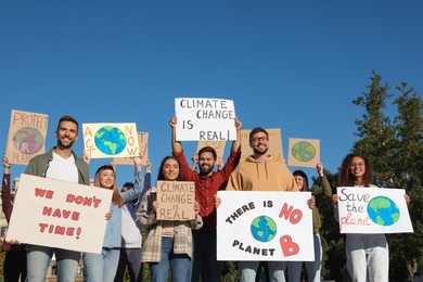 Photo of Group of people with posters protesting against climate change outdoors