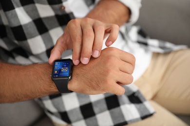 Man with smart watch indoors, closeup view