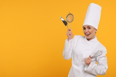 Photo of Happy confectioner in uniform holding professional tools on yellow background. Space for text