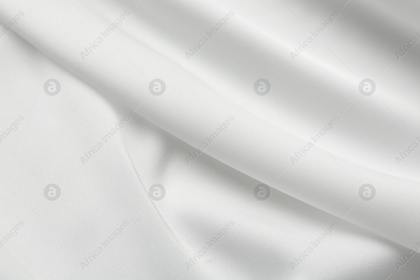 Photo of Texture of white silk ripple fabric as background, top view