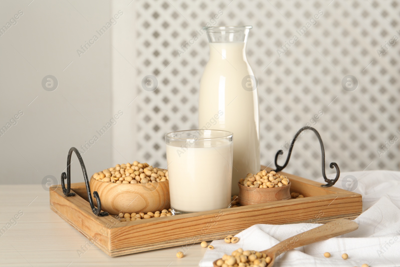 Photo of Fresh soy milk and beans on wooden table