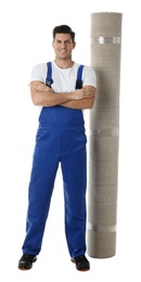 Photo of Male worker with rolled carpet on white background