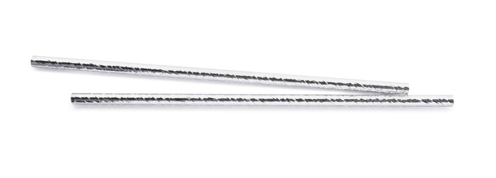 Photo of Silver plastic cocktail straws on white background, top view