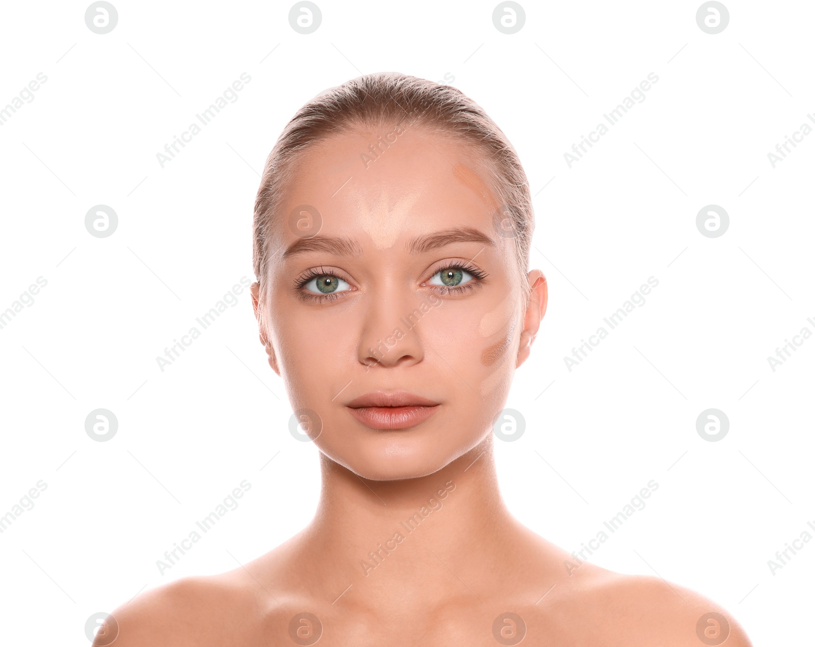 Photo of Young woman with different shades of skin foundation on her face against white background