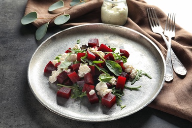 Plate with delicious beet salad served on table