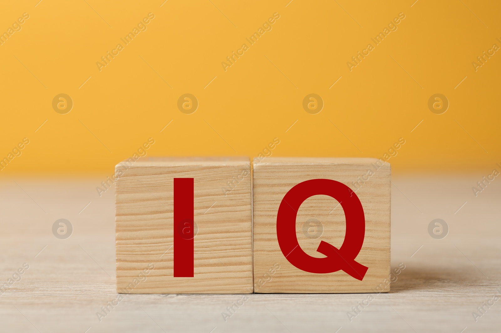 Photo of Wooden cubes with abbreviation IQ on table. Space for text